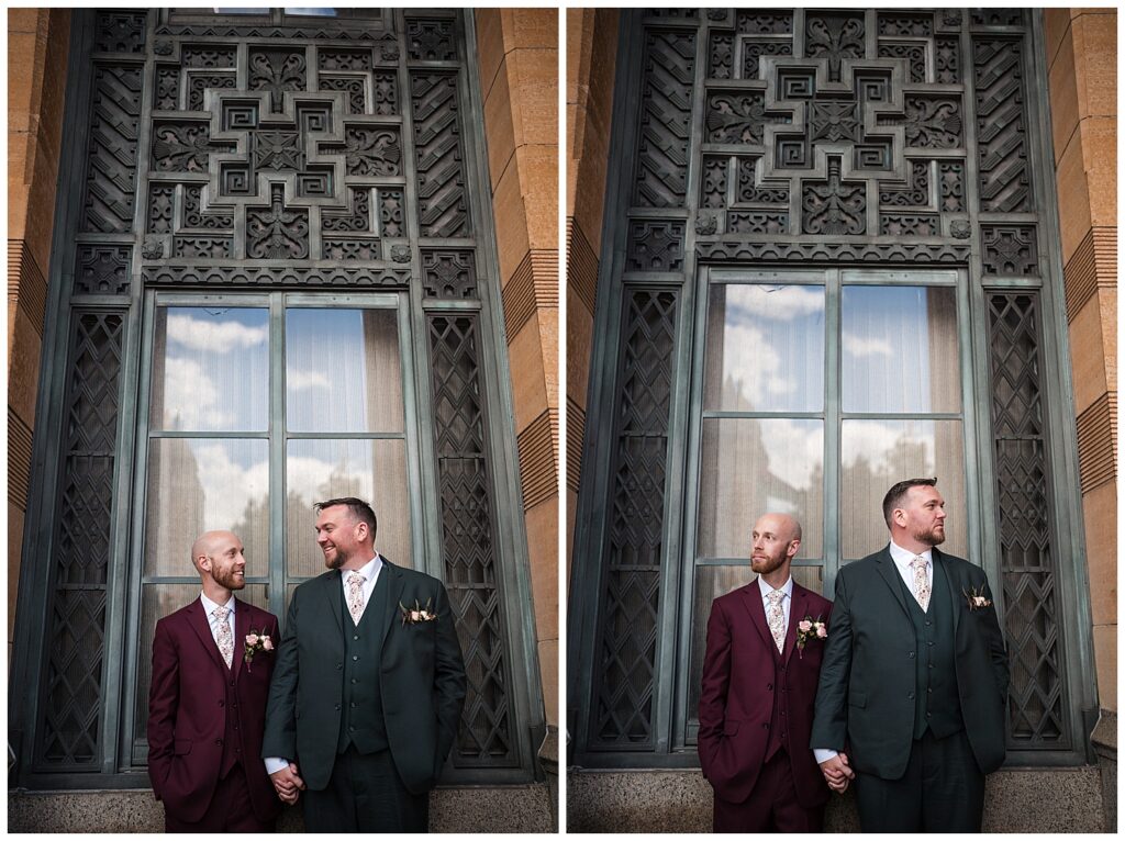 Brian and Jeff stand holding hands in front of Buffalo city hall