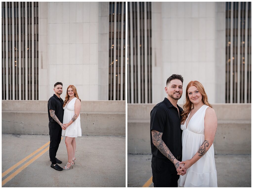 emma and nick stand and look at camera on top of a parking garage in downtown Buffalo NY