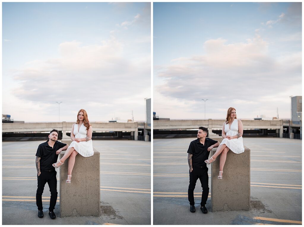 Emma is sitting on a raised concrete block while nick poses beside her on top of a parking garage in downtown Buffalo NY