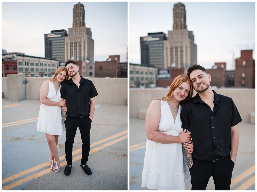 Emma and Nick lean on each other for a photo on top of a parking garage in downtown Buffalo NY