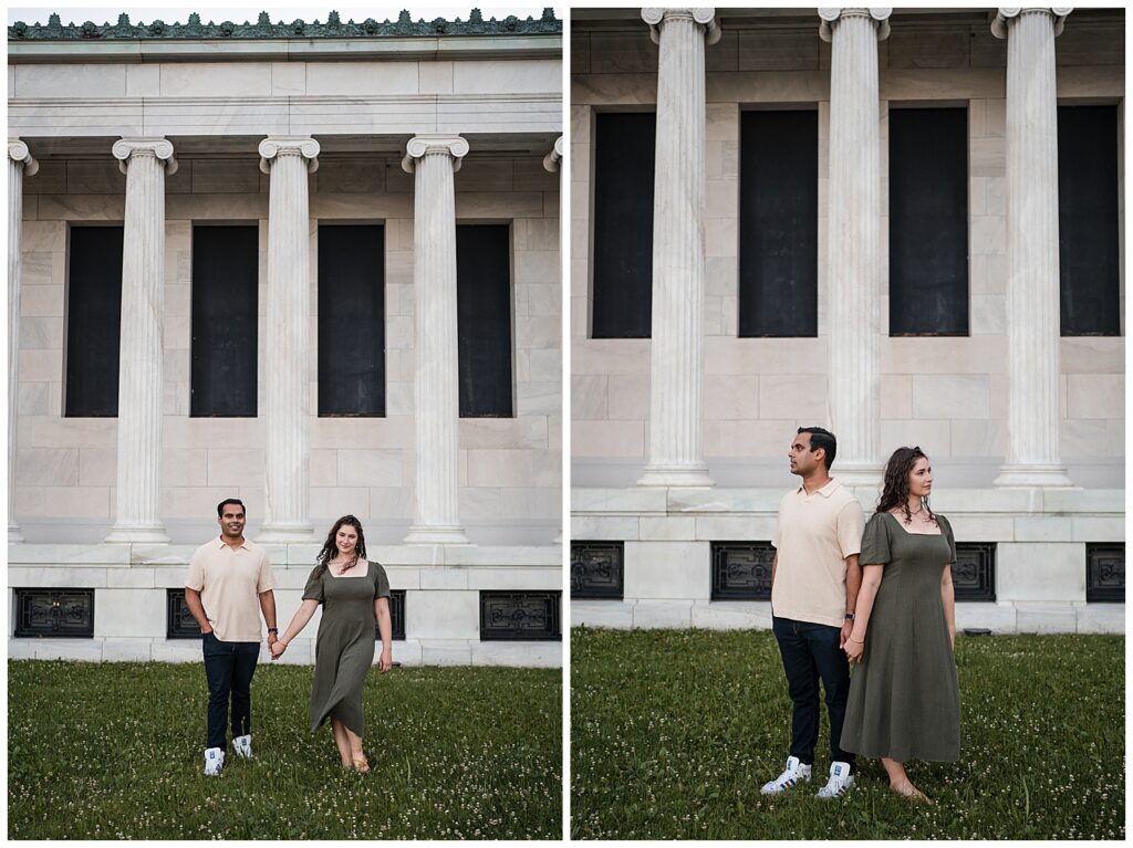Sarah and Ankur hold hands while posing for a photo in front of the Albright Knox art gallery