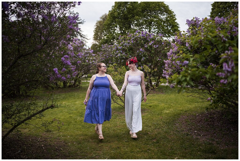 Cas and Kaylie walk through the lilacs in full bloom at highland park