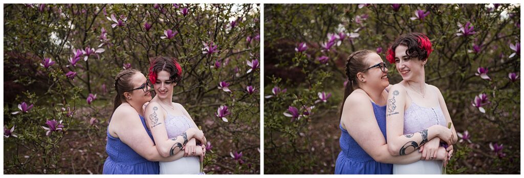 Cas and Kaylie pose in a hug in front of pink lilacs