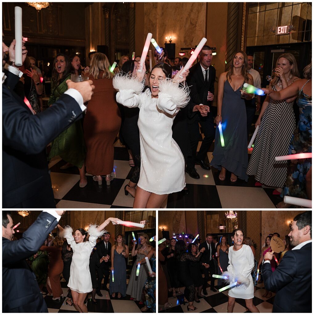 bride and groom dancing with their guests at the wedding reception. They have light up wands to wave in the air.